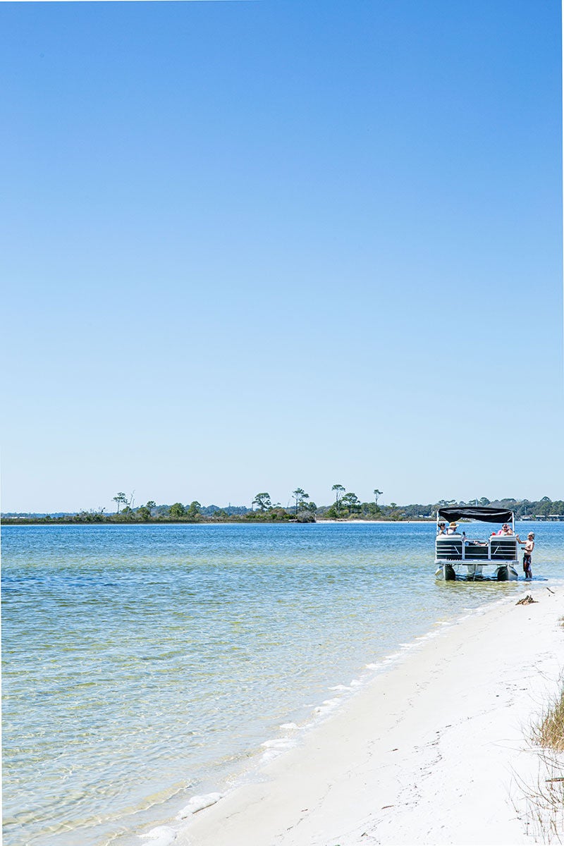 people enjoying a pontoon on the Emerald Coast