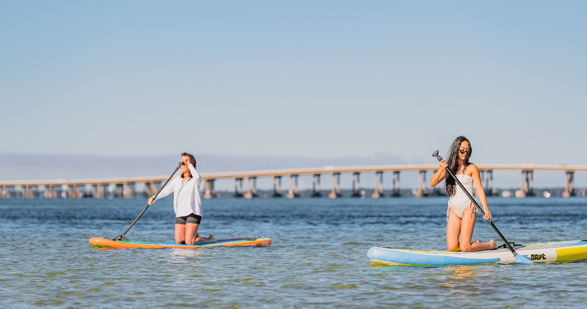 girls on paddle boards