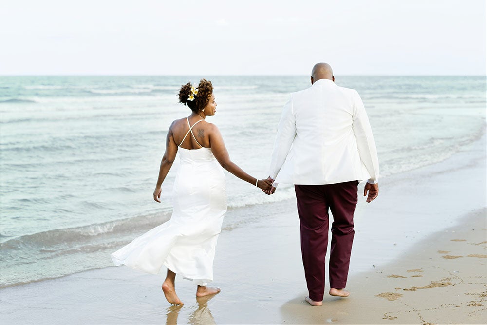 African American couple getting married on the beach