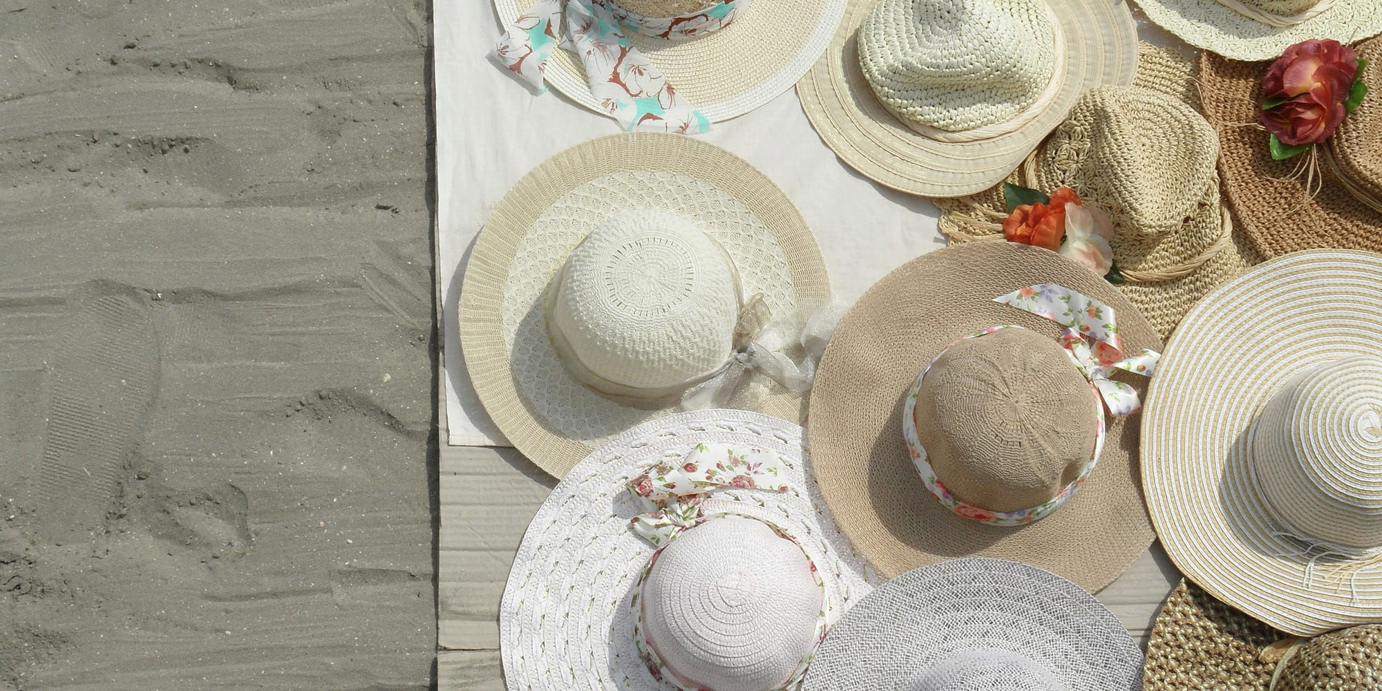 Hats on towel in the sand