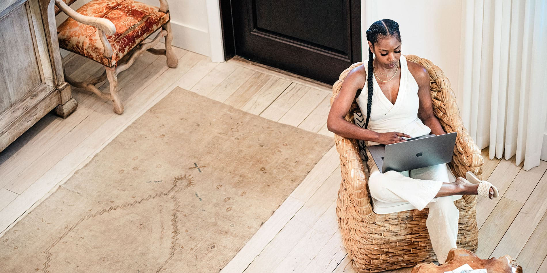 woman on laptop sitting in beach home on the Emerald Coast